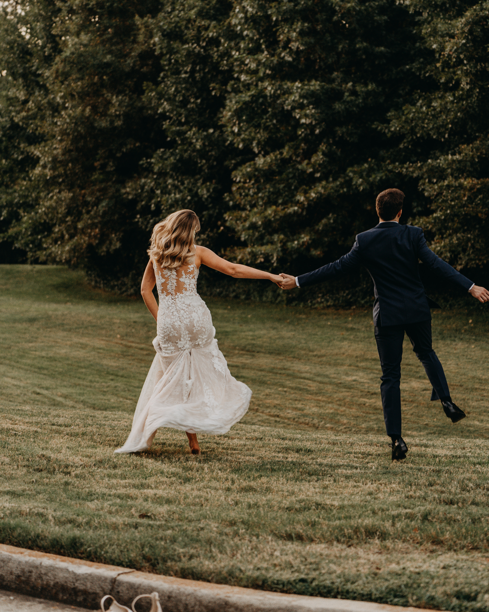 A Couple Walking on the Grass Field